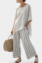 Fiorella – blusa asimmetrica elegante e pantaloni a righe