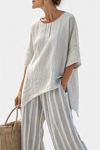 Fiorella – blusa asimmetrica elegante e pantaloni a righe